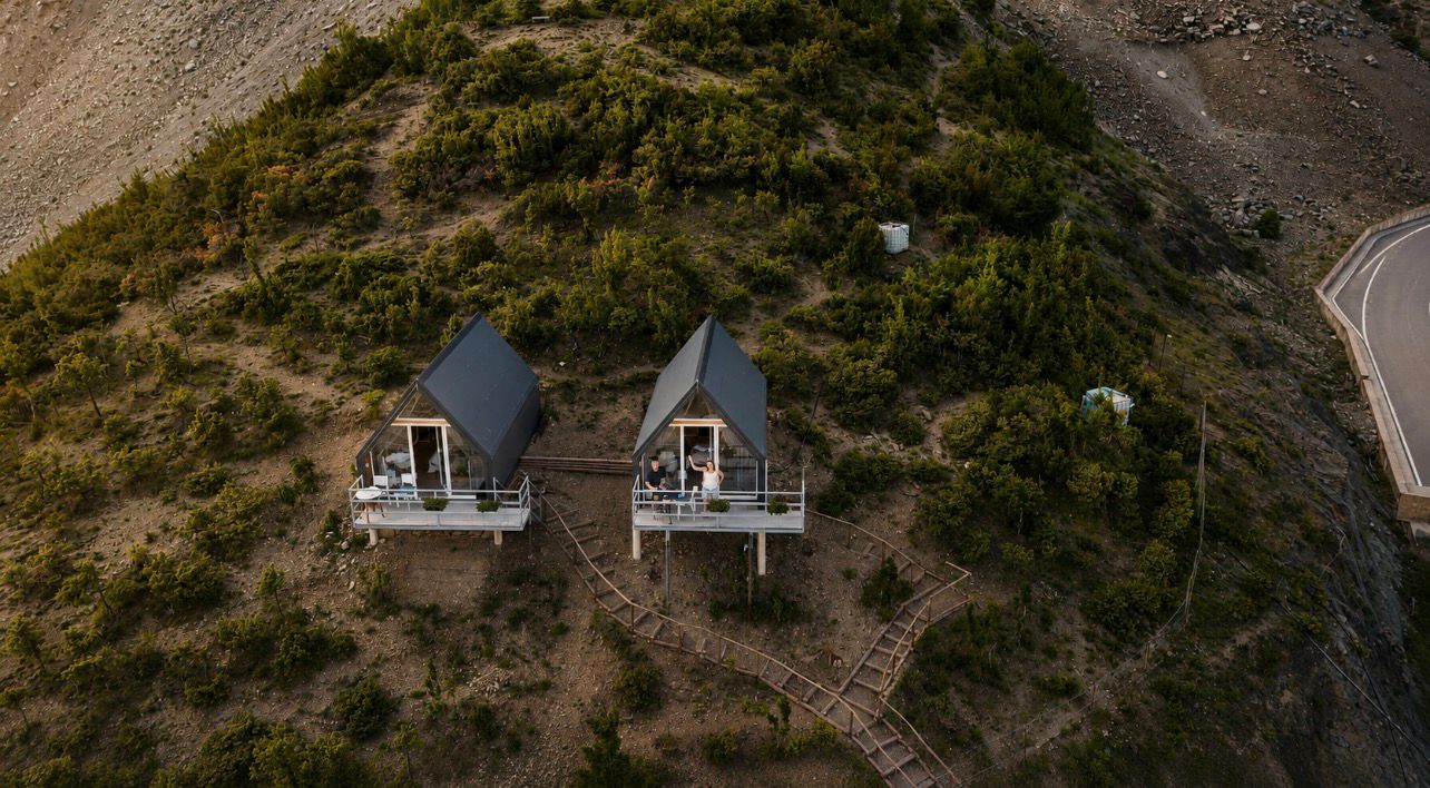 Two A-frame couple cabins on the mountain ridge above Koman