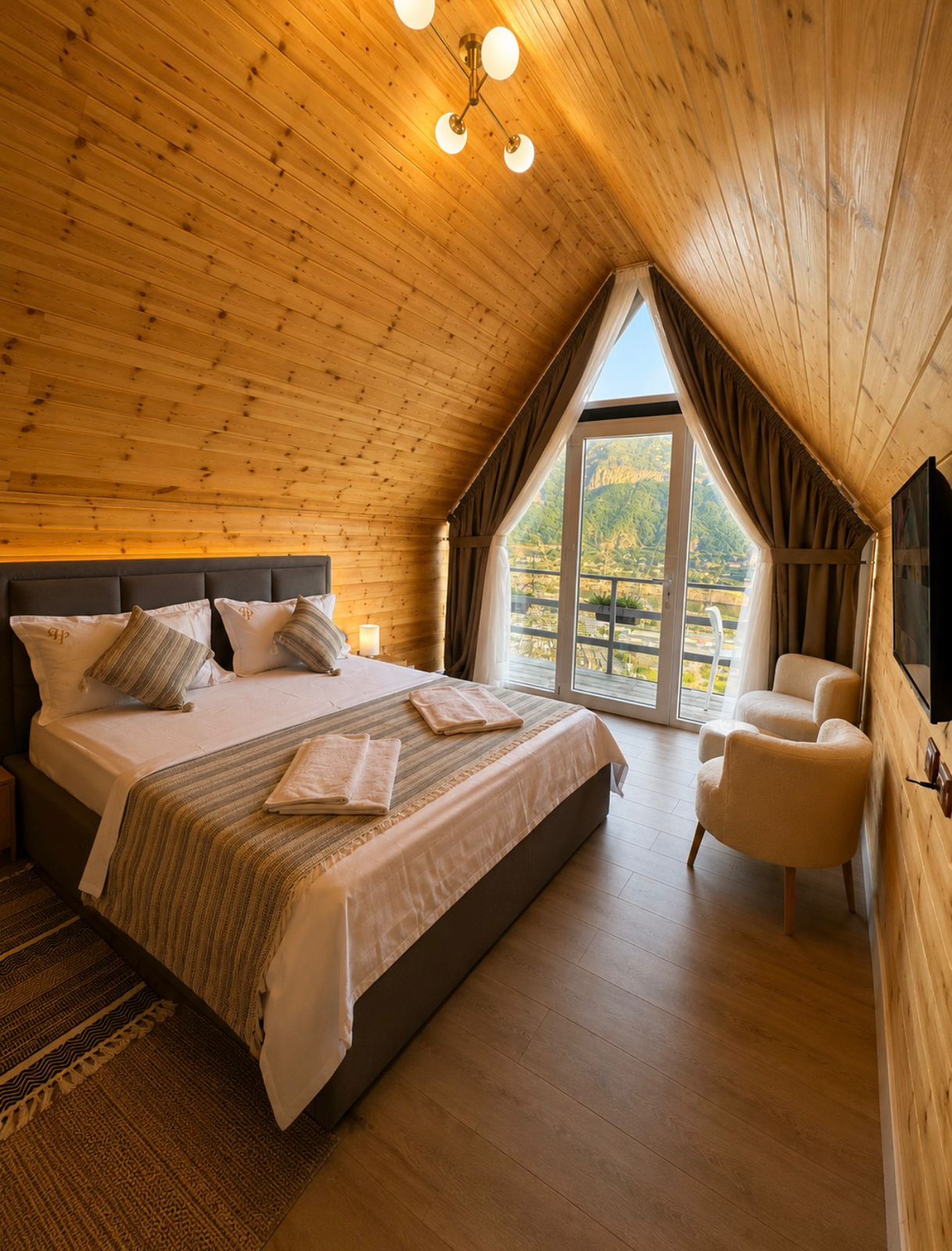 Couple cabin bed with A-frame window and mountain view